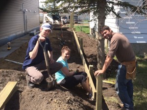 Cargill Employees Thomas Mauthe, Heather Fleck and Nathan Hildebrandt spent the day building the fence and retaining wall for the Habitat for Humanity Home being built in North East Camrose.