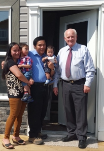 Jomer and Angel receive the key to their Habitat home from Camrose Mayor, Norm Mayer.